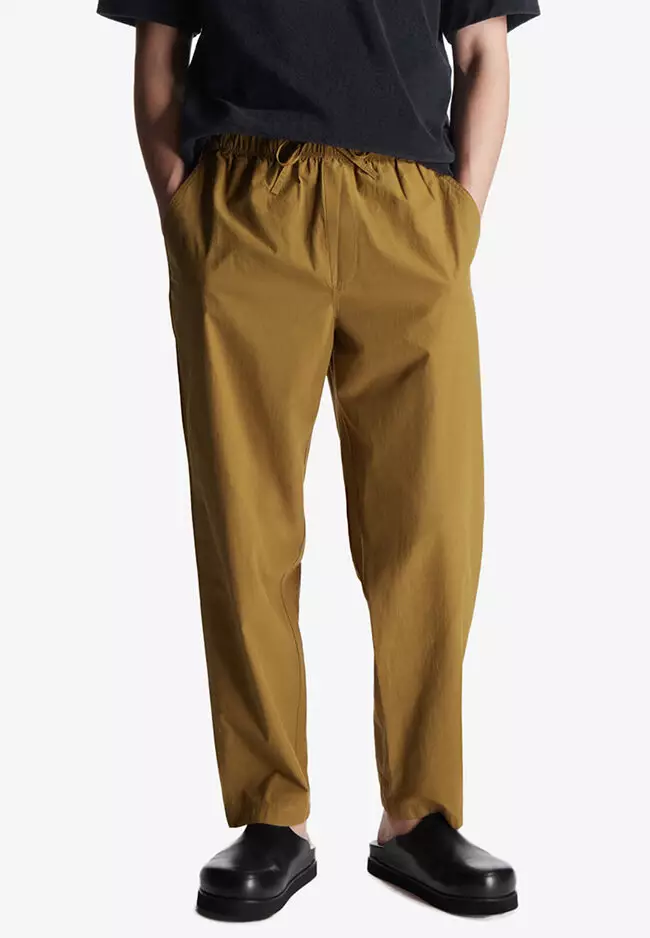 Buy COS Relaxed-Fit Tapered Trousers 2024 Online