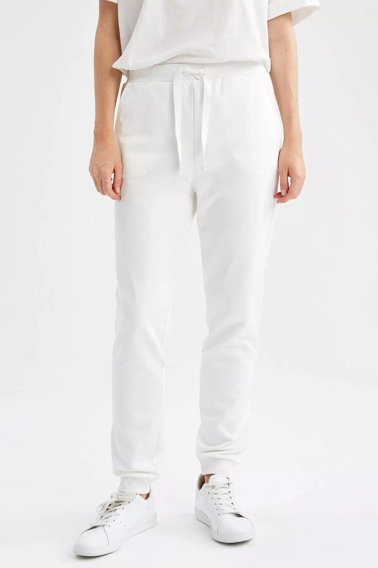 White sweatpants with top pockets