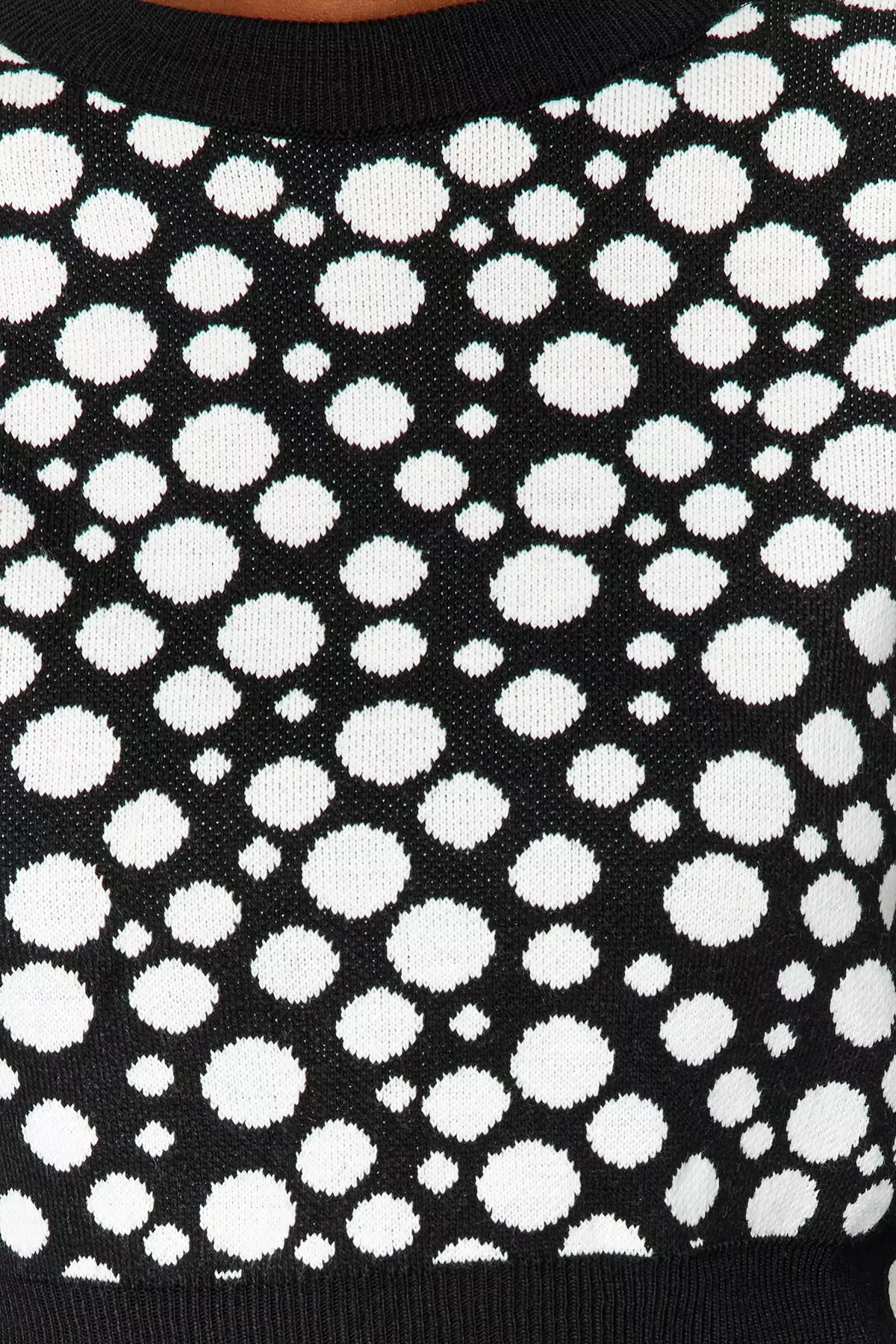 White sweater with store black polka dots