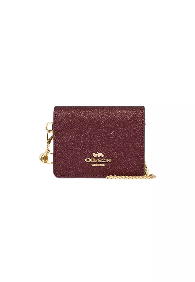 boxed mini wallet on a chain coach