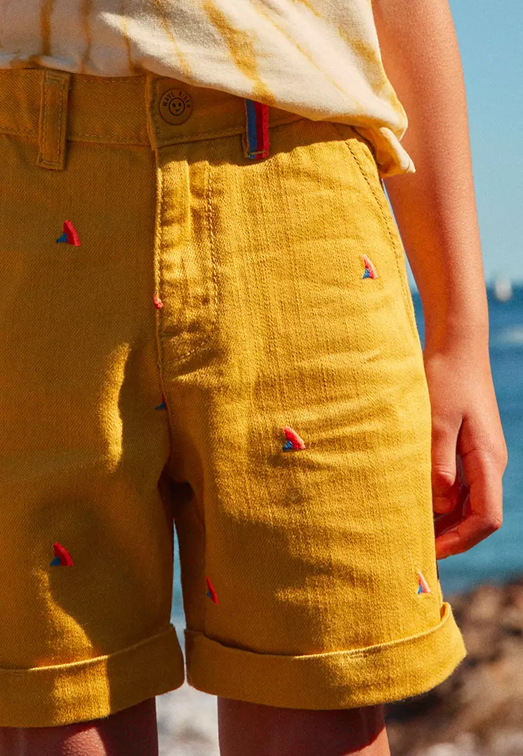 MUSTARD SHORTS WITH MULTICOLOURED SHARK FIN EMBROIDERIES