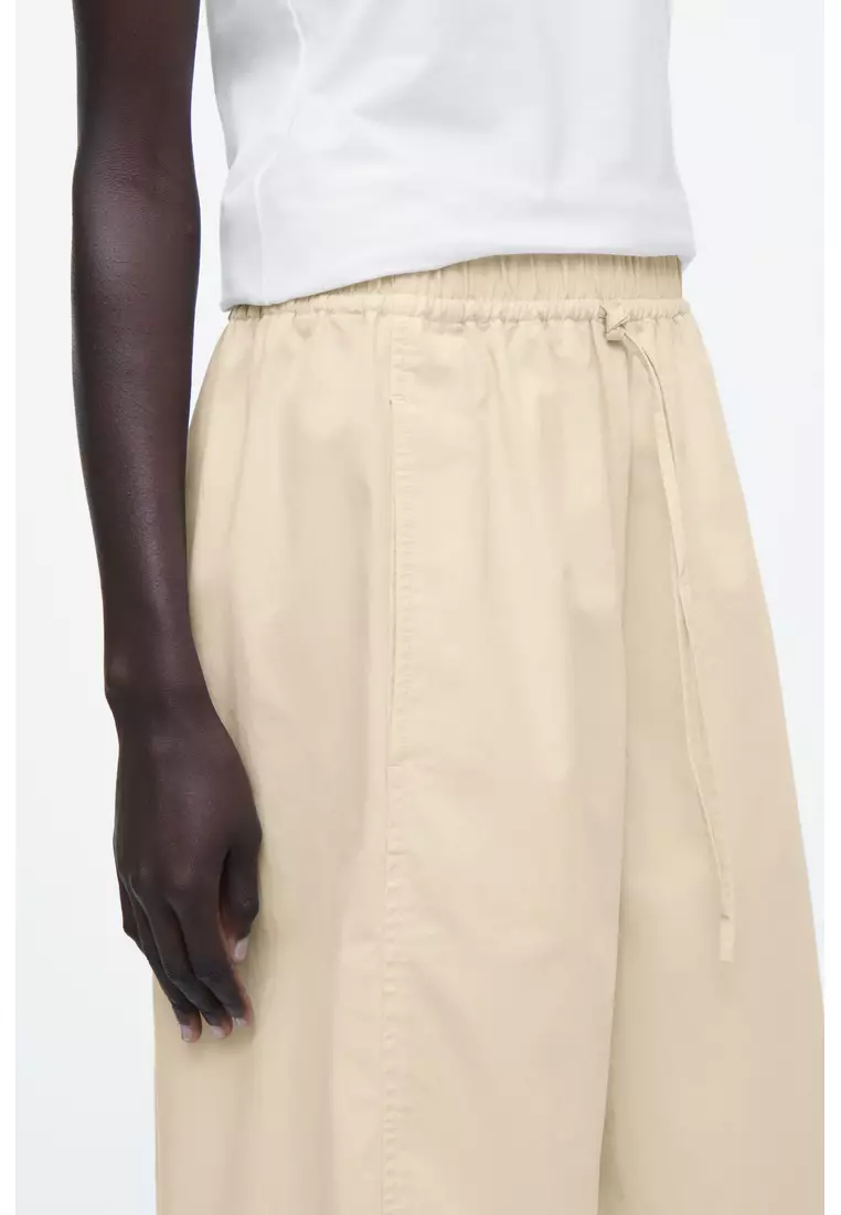 ELASTICATED BARREL-LEG TROUSERS