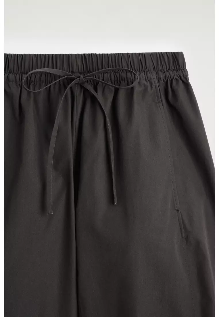 ELASTICATED BARREL-LEG TROUSERS