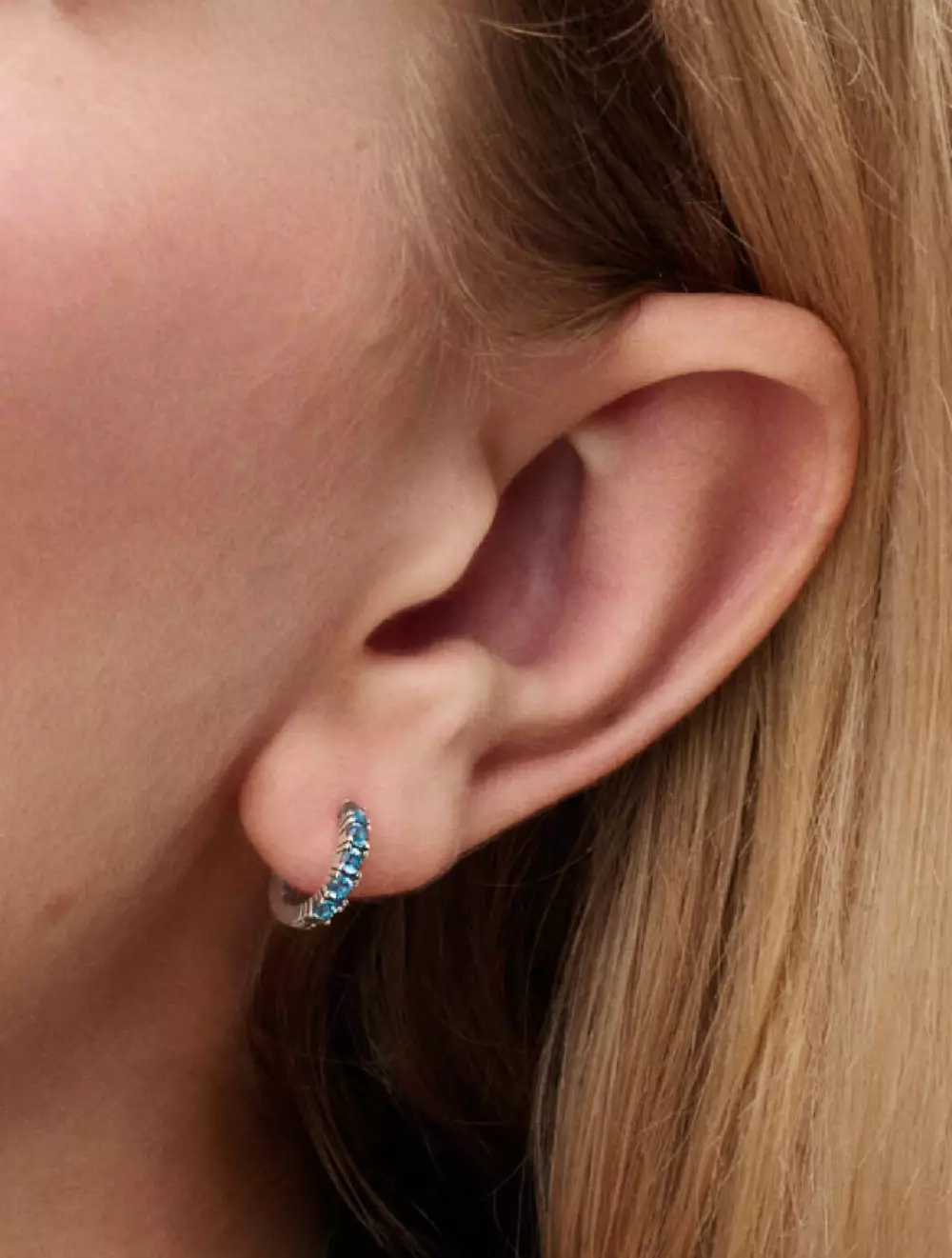 Sterling silver huggie earrings with aquamarine blue crystal