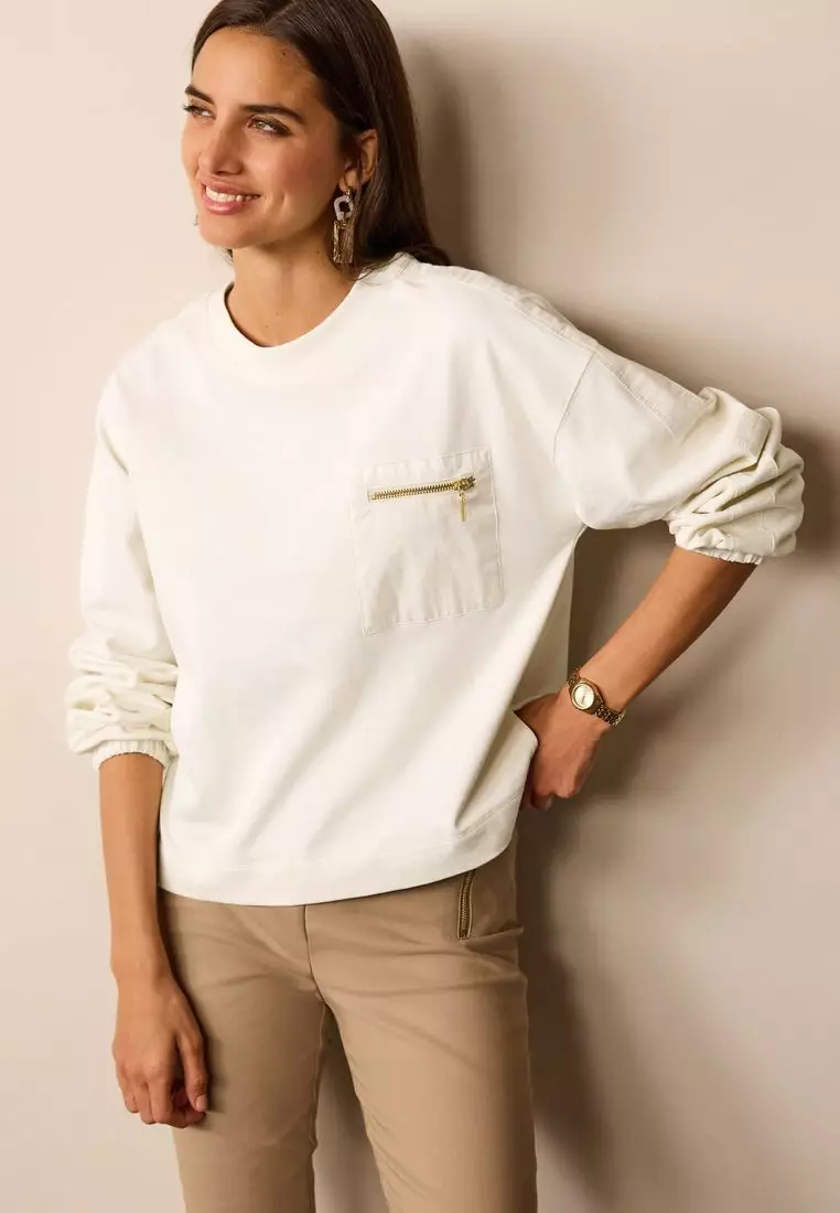 White sweater store with pockets