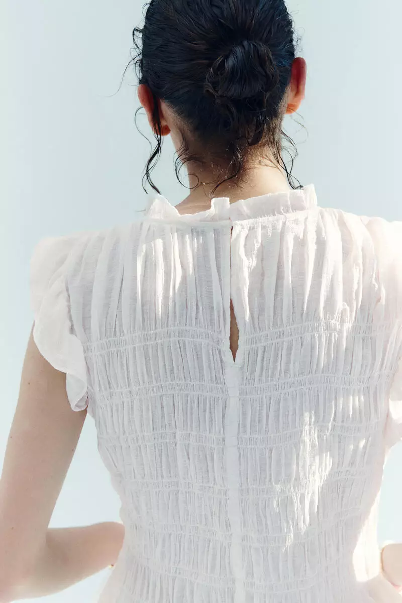Smocked peplum top