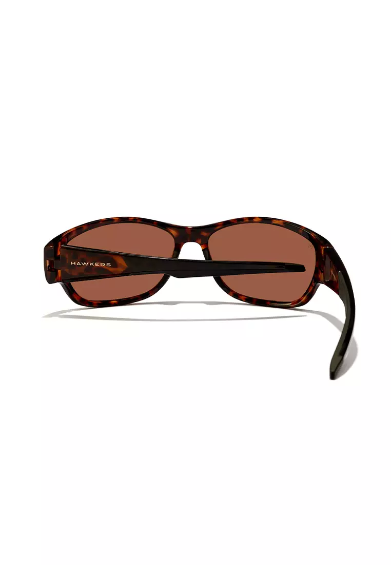 HAWKERS POLARIZED Carey Brown RAVE Sunglasses for Men and Women, Unisex. UV400 Protection. Official Product designed in Spain