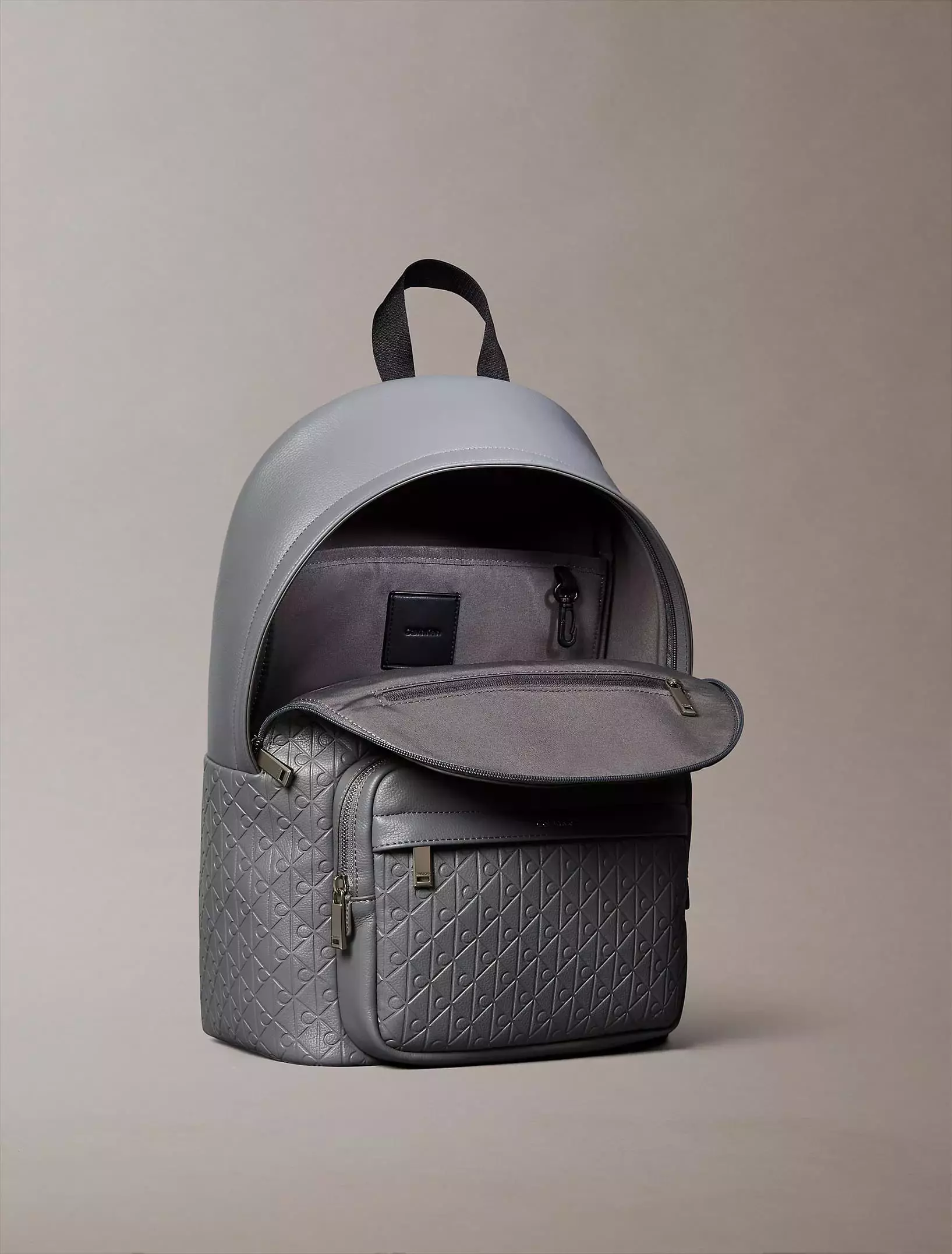 Calvin Klein - Calvin Klein Emblem AOP Embossed Round Backpack