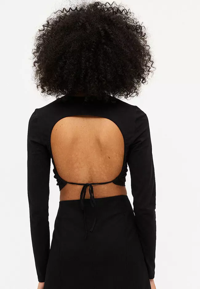 Grounded Turtleneck Backless Long-Sleeve Crop Top in Black