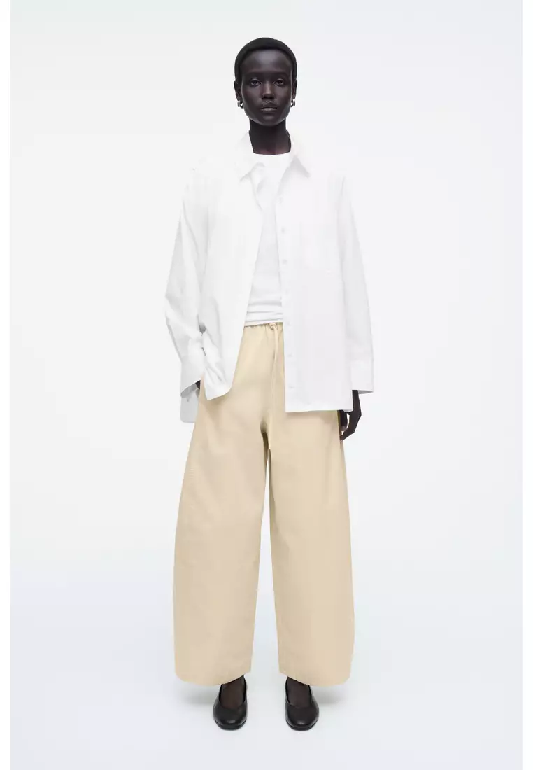 ELASTICATED BARREL-LEG TROUSERS