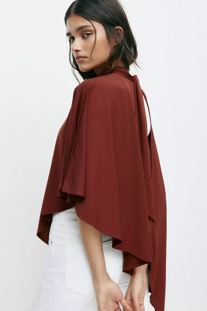 Asymmetric cape top